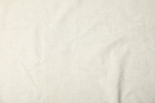 Fototapeta Texture of beige tablecloth as background, top view