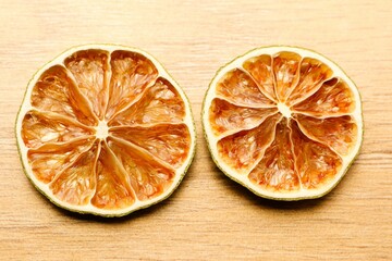 Beautifully Dried Citrus Fruit Slices on a Rustic Wooden Background for Your Enjoyment