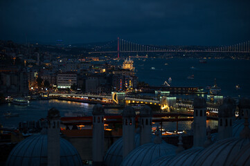 Night view of Istanbul, Turkey. The Bosphorus Strait is illuminated, with the city lights twinkling...