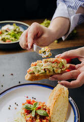 Fresh guacamole bruschetta topped with colorful vegetables, served on a crispy baguette slice
