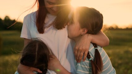 Family reunion field, Children running mom, Outdoor fun during sunset, Happy family moments, Summer evening joy, Kid mom embrace, Warm sunset nature, Family bonding time, Scenic outdoor playtime.