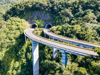 Rota do Sol Highway - aerial view of curved tunnels followed by viaducts on a scenic road in Serra...