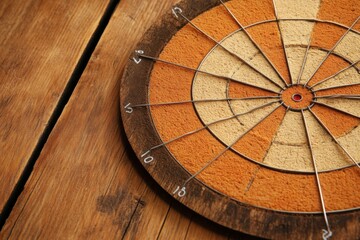 Play darts on a wooden target with a black and brown bull's-eye and a red dot in the center. There is a dart sticking out of the apple, success is victory, hitting the target