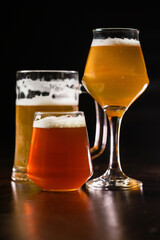 Variety of beer glasses with different types of beer on wooden table. Close-up.
