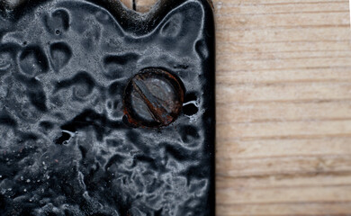 Close up of the head of a cast iron screw