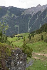 Alpine Valley with Wooden Huts and Rugged Rock Formation in Zillertal, Tirol, Austria