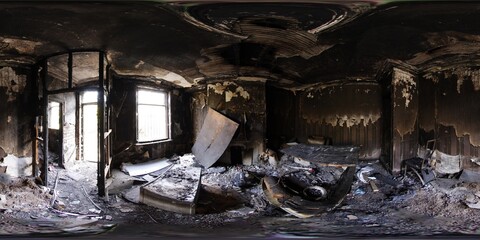 360 Degree panoramic sphere photo taken of an extremely run down property that has had a massive fire showing the burnt walls floors and furniture in the living room area of the fire damaged house