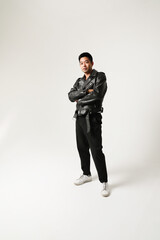 Portrait of young Asian man looking at the camera posing indoor. Vertical.