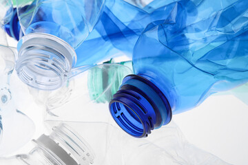 Crumpled plastic bottles on white background, closeup