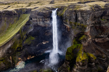 Majestic aerial drone view of Haifoss and Granni waterfalls in Iceland cascading in rugged canyon setting