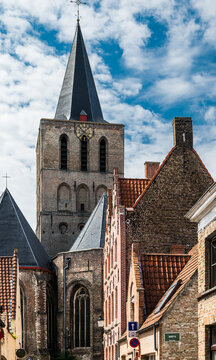Monastery tower and medieval houses in the old town of Bruges, Belgium
