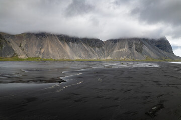 Scenic view of volcanic black sand beach in Stokksnes in Iceland with majestic Vestrahorn mountain landscape