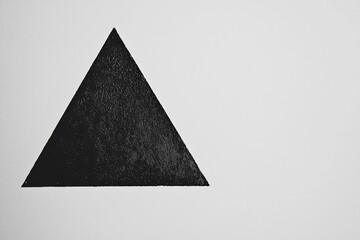Fototapeta premium Abstract black triangle on a white background, creating a minimalist design suitable for modern art