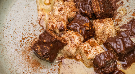 Melting chocolate and creamy dessert with cinnamon topping. Dessert features dark and white chocolate layers.
