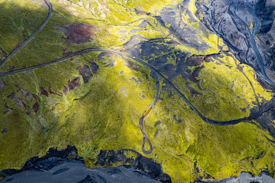 Aerial drone view exploring a river valley landscape with a amazing glacial basin very close to Thakgil (Pakgil) campsite near Vik in Iceland. M.ountains in the background