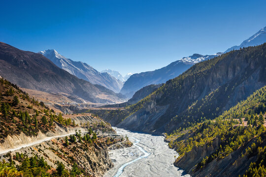 Autumn landscape in Himalaya mountains in Nepal. Marsyangdi river valley with Pisang peak, Ngadi chuli and Annapurna II mounts in sunny day. Around Annapurna trekking.