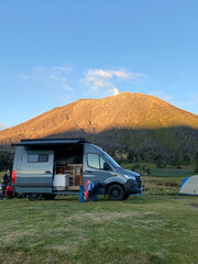 Sprinter camper van parked under active Turrialba volcano