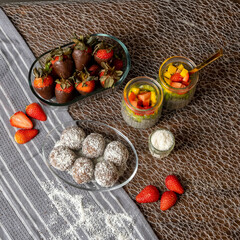 Healthy Dessert Platter with Chocolate-Dipped Strawberries, Coconut Energy Balls, and Chia Pudding