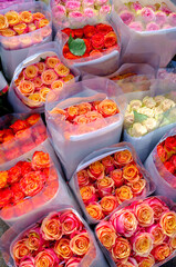 A stunning display of orange and peach roses, carefully packed and ready for sale. Their warm tones evoke feelings of joy, passion, and elegance