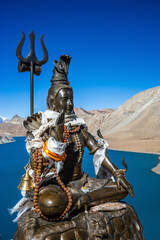 Lord Shiva statue on the Tilicho lake bank. Sacred to Hindus and Buddhists lake is located on the Around Annapurna trekking route in Himalaya mountains, Nepal.