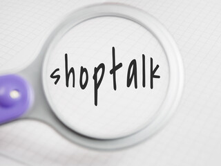 Shoptalk title text through a magnifying glass on a notepad background