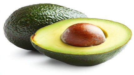Close-up of two fresh avocados one whole and one cut in half showing the seed