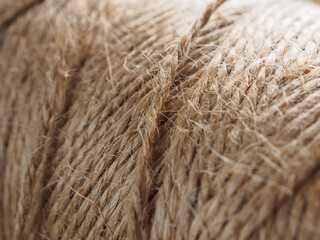 A close-up of a finely woven rope. The intricate texture and detail of the weave are clearly visible.