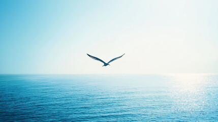 Fototapeta premium A solitary bird soaring over a tranquil ocean at sunrise, creating a serene and peaceful atmosphere