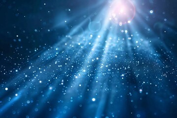Fototapeta premium Shiny light beams illuminating blue particles on abstract background