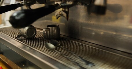 Dirty professional metal coffee machine with coffee grounds remnants close up on countertop espresso machine stains in kitchen barista workspace used for brewing coffee fresh espresso machine cleanup