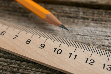 Ruler and pencil on wooden table, closeup