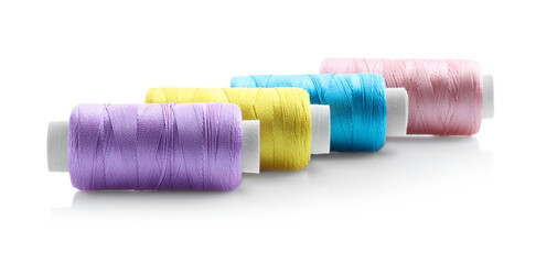 Spools of bright sewing threads isolated on white