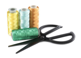 Spools of thread and scissors isolated on white. Sewing supplies