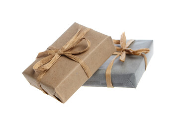 Two sustainable gifts wrapped in biodegradable kraft and gray paper, tied with natural fiber twine bows. A plastic-free and zero-waste packaging option on a white background