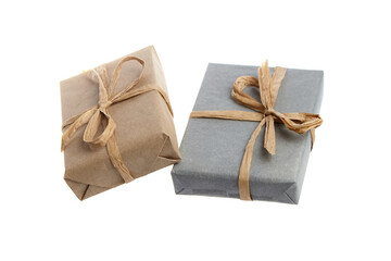 Two sustainable gifts wrapped in biodegradable kraft and gray paper, tied with natural fiber twine bows. A plastic-free and zero-waste gift wrapping option on a white background