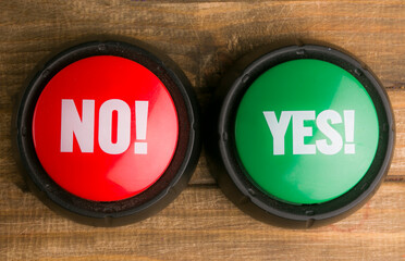 two buttons yes and no on a wooden background