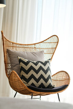 Cozy Rattan Chair with Chevron Cushion in Hotel Room Decor