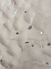 Dry sand with stones. Natural background.