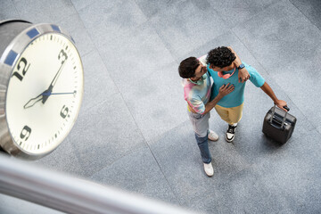 Romantic embrace of a gay couple at the train station