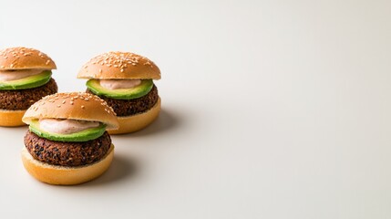 top-down view of mini veggie sliders made with black bean patties avocado slices and chipotle mayo served on seeded