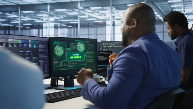 Data scientists receive access granted notification while reconfiguring server hub, optimizing it. Team of IT experts ensures data center operates efficiently, successfully eliminating all errors - Powered by Adobe