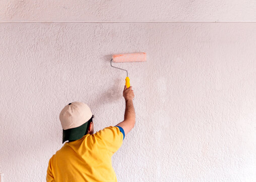 Man painting a wall during home remodeling