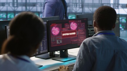 Cybersecurity team monitoring security incidents, alerted by security breach alert, working...