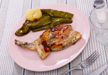 Delicious fried rabbit served with peppers and onions on platter