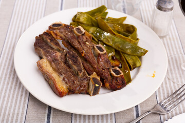 Appetizing roasted beef served with green beans on platter