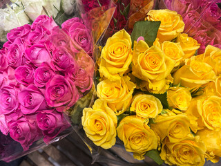 bright yellow and pink spring roses bouquet arrangement, sales display. top down, full frame