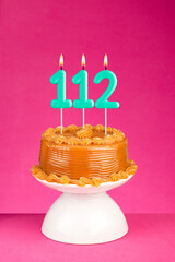 Birthday card with candle number 112 - Cake with dulce de leche frosting.