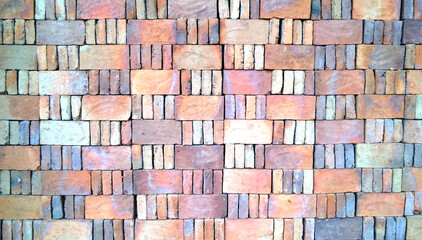 a pile of red bricks formed like a pattern
