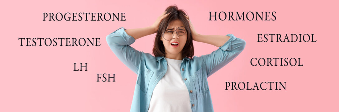 Beautiful young stressed woman on pink background. Stress Awareness Month