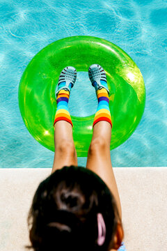 Colorful poolside fun with green float and rainbow vibes